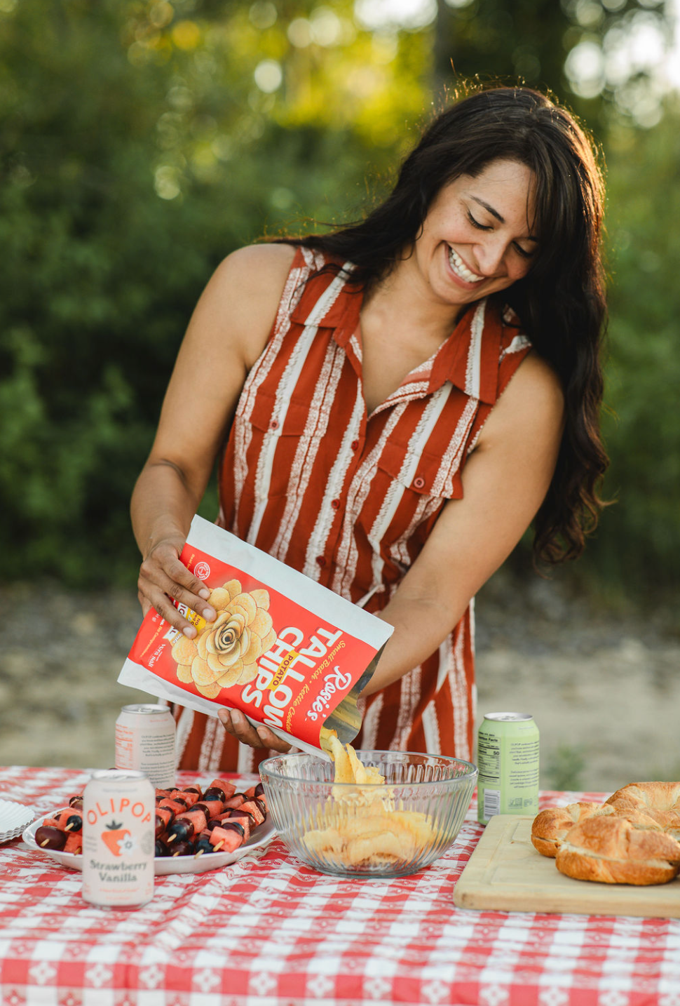 Snacks without seed oils displayed on the tabletop of a picnic table including Rosie's Chips.